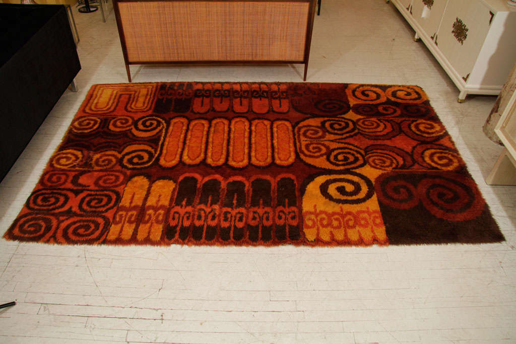Vintage Rya from the 1960s in a rust, brown, red. orange and gold palette. The dimensions are 70 inches x 116 inches. Please note condition details, and please contact for location.